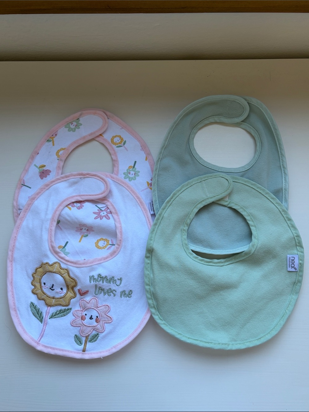 Neat Solutions - 4 pack of Soft Pastel Bibs in Pink Floral, Pastel Blue, & Mint